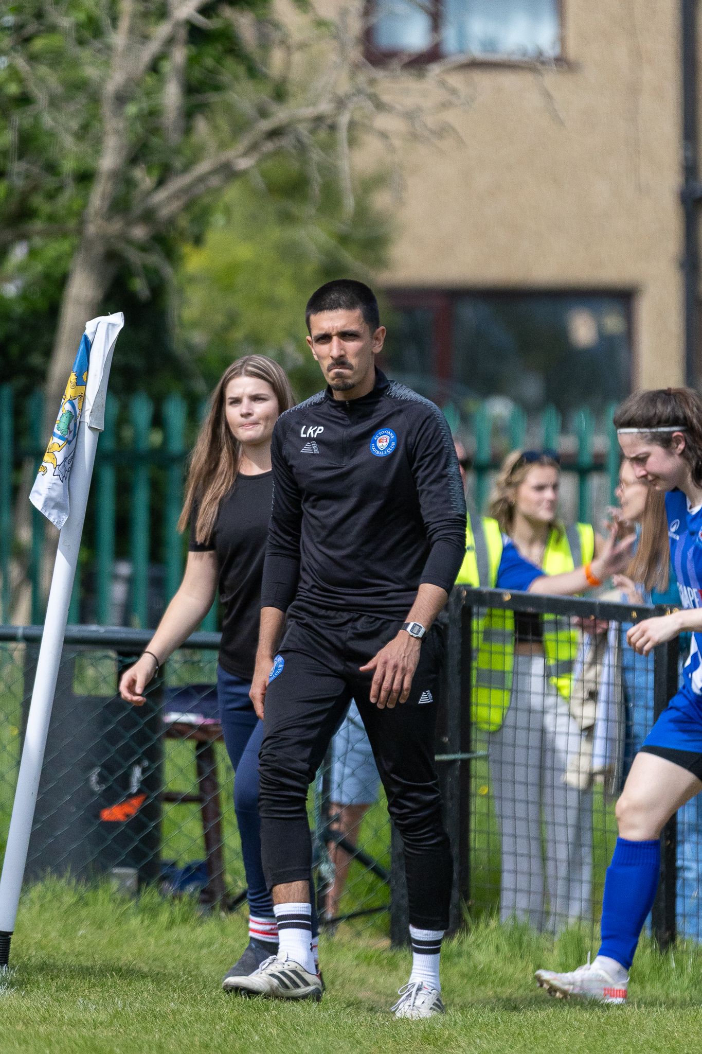Loki on the touchline with players before a match